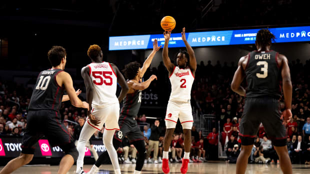 Cincinnati Bearcats guard Jizzle James (2) hits a 3-point basket as Oklahoma Sooners guard Milos Uzan (12) guards him in the second half of the NCAA basketball game between Cincinnati Bearcats and Oklahoma Sooners at Fifth Third Arena in Cincinnati on Saturday, Jan. 20, 2024.
